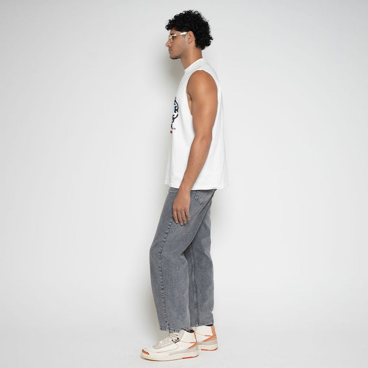 Side profile view of model in white Faded Mob Palace Sleeveless T-Shirt by Flashmob Nation India.