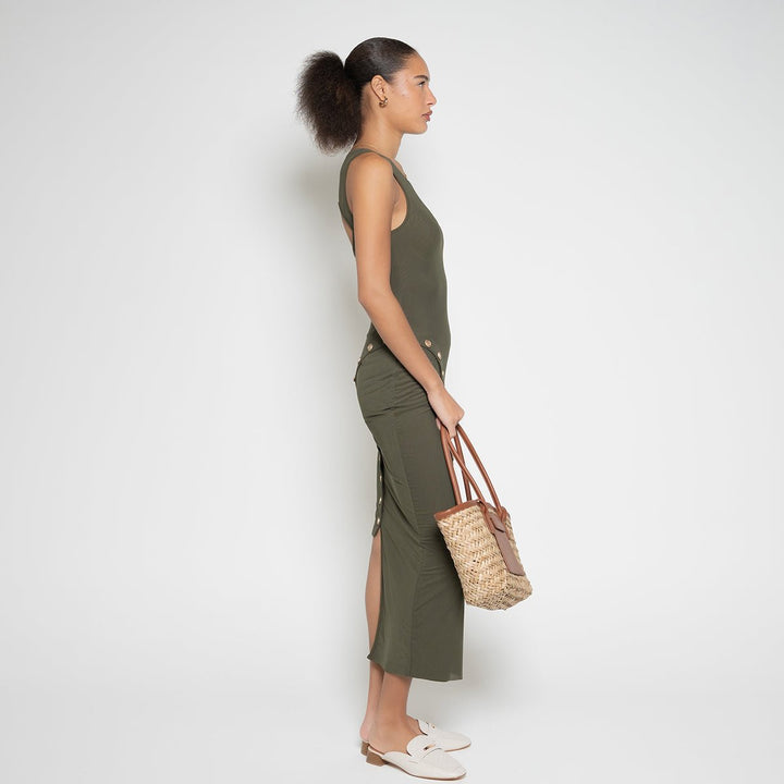 Left side profile of a model wearing the olive green knitted FM Buttoned Maxi Dress by Flashmob Nation.