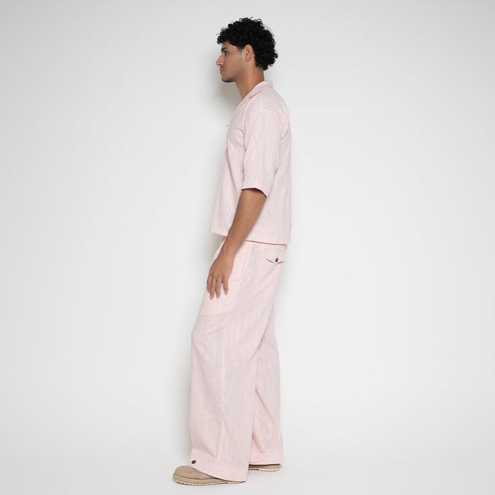 Side full length view of model wearing Men's Linen-Blend Carpenter Pants in Pink Ombre by Flashmob Nation.