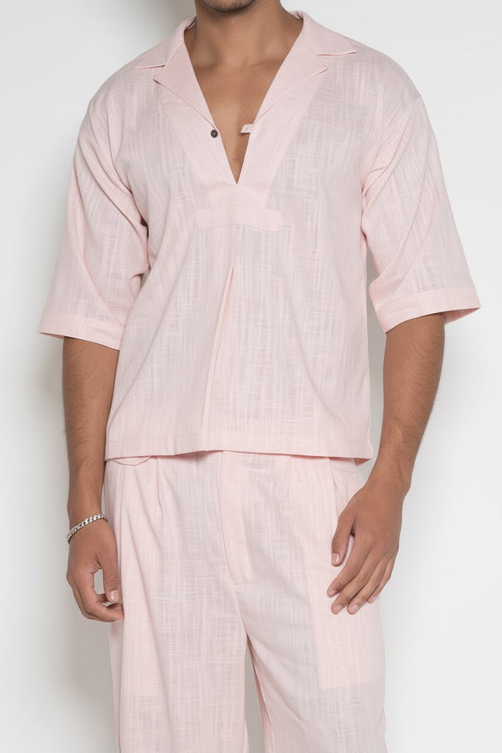Cropped front view of model in pink V-Neck Box Shirt and matching linen pants by Flashmob Nation India.