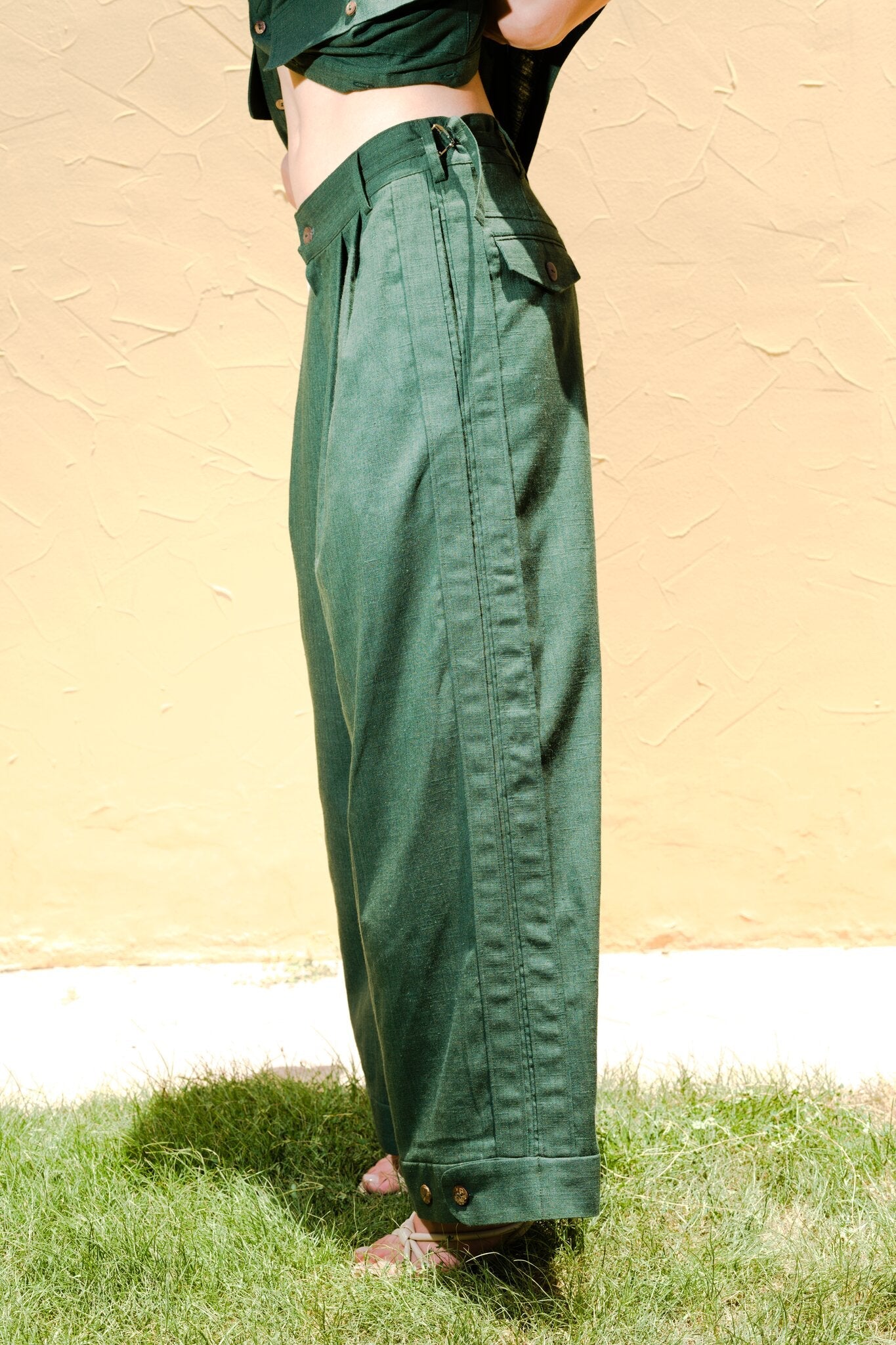 Side profile view showing the drape and pocket detailing of Women's Army Green Linen Pants by Flashmob Nation India.